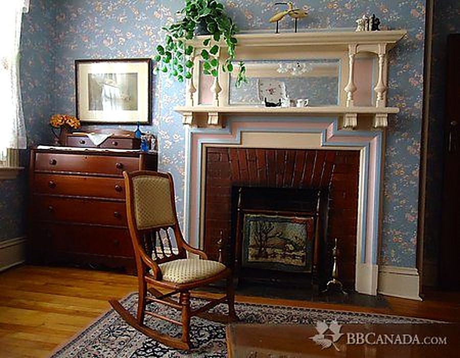 Original fireplace with decorative mantel and rocking chair
